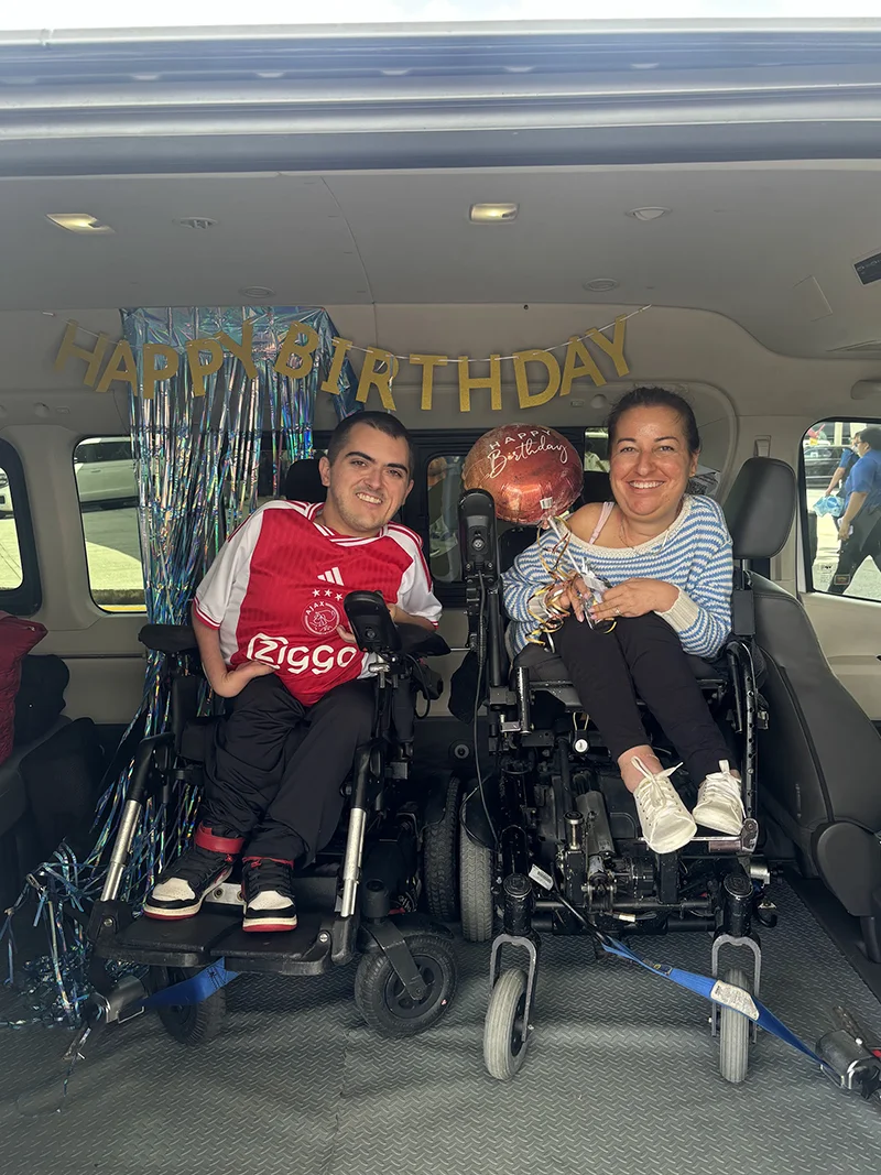 Accessible van transfer in Cancun with wheelchair user boarding and travel group outside the vehicle