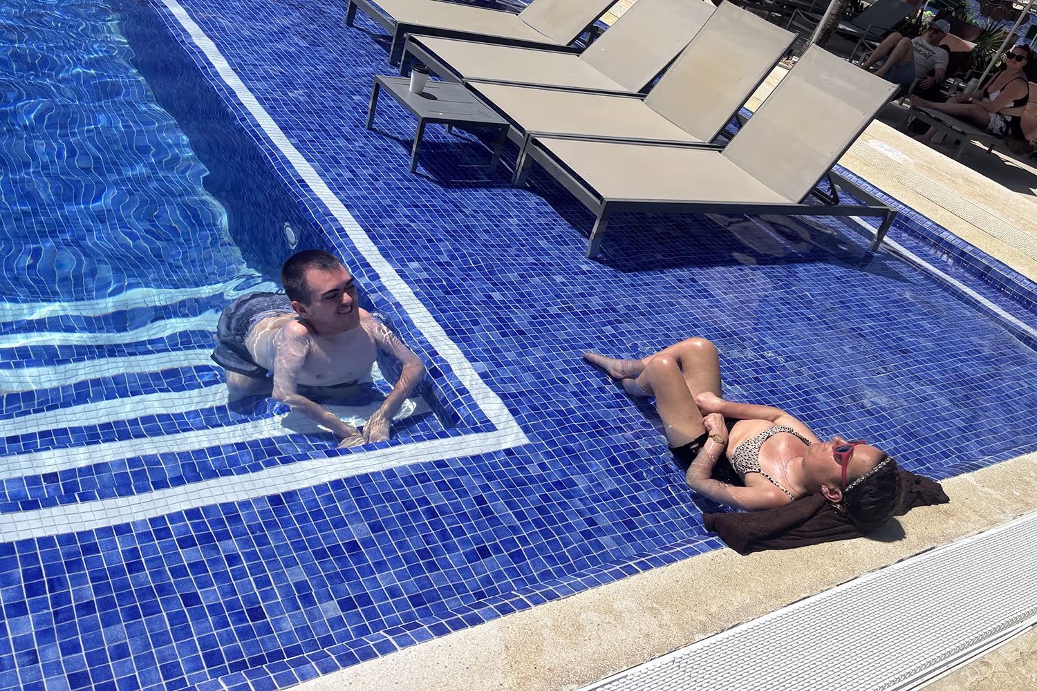 Couple relaxing in a shallow section of the pool at Royalton Riviera Cancun