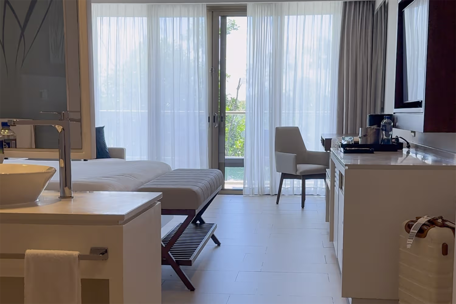 Interior of a guest room at Royalton Riviera Cancun with beds, seating area, and balcony