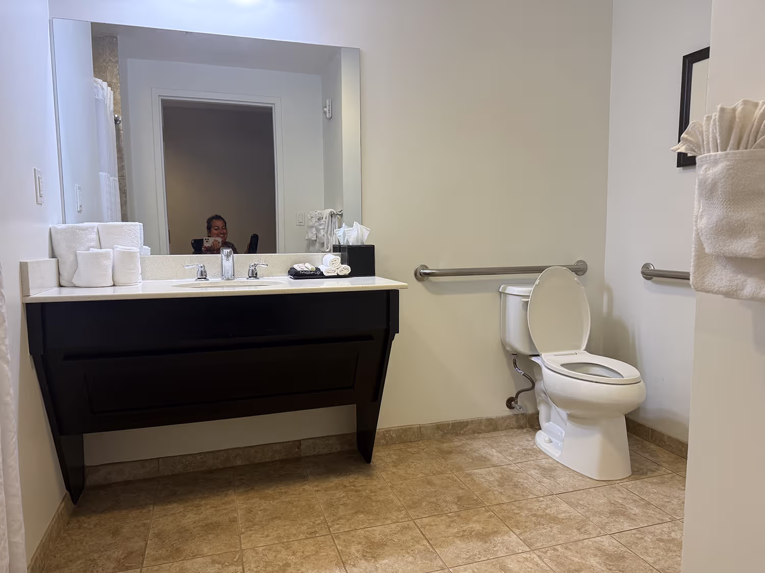 Spacious accessible bathroom at Shephard’s Beach Resort with grab bars beside the toilet