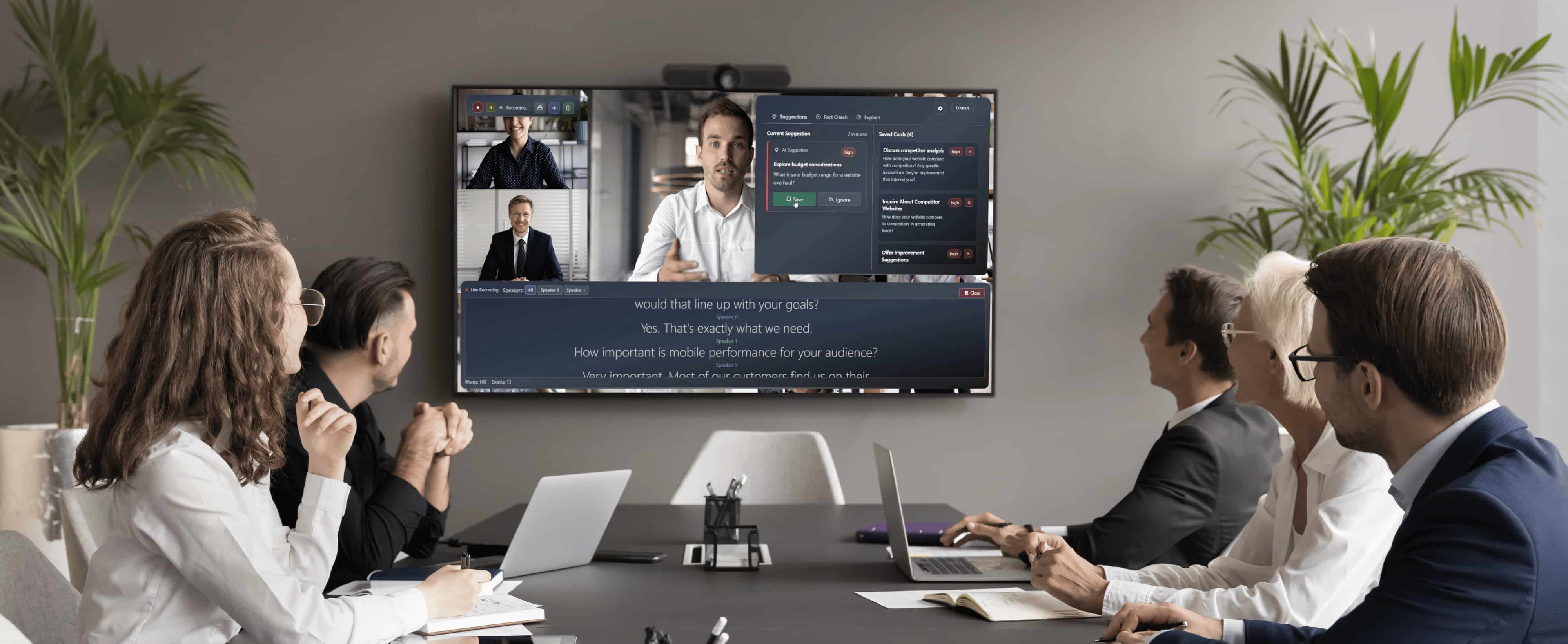Four business professionals in a conference room attending a video meeting displayed on a large screen. Modus giving real time suggestions.