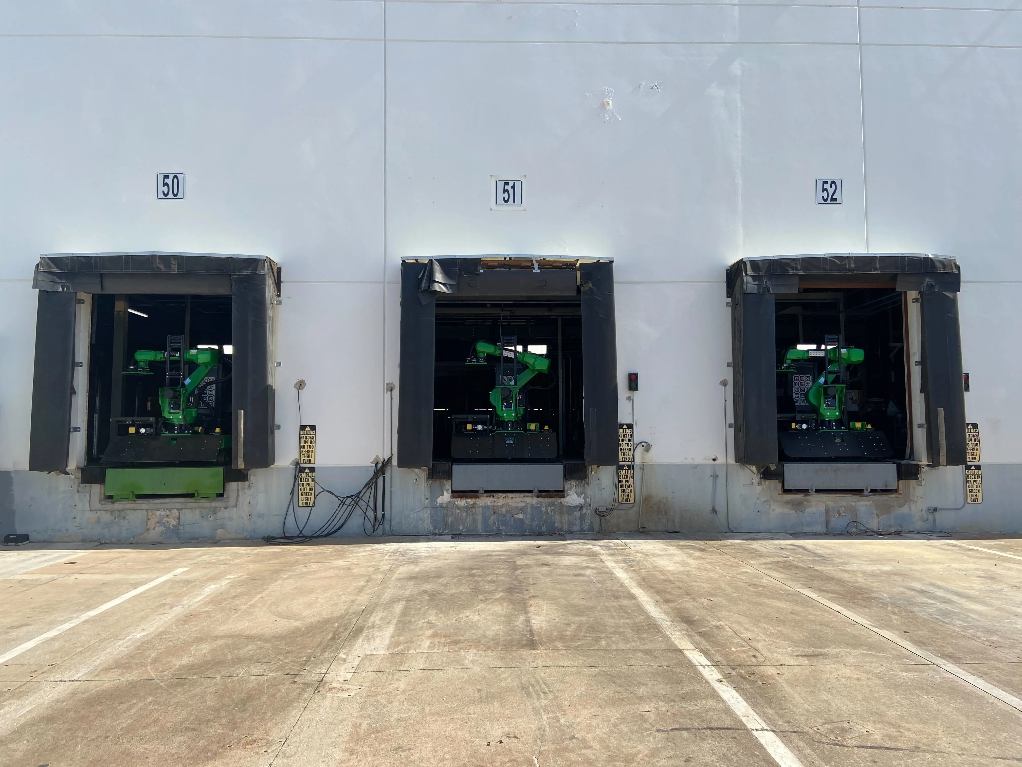 3 pickle robots in a loading bay