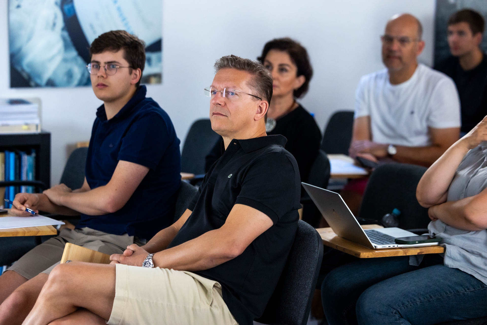 Students listen to Dr. Mora lecture on bright room