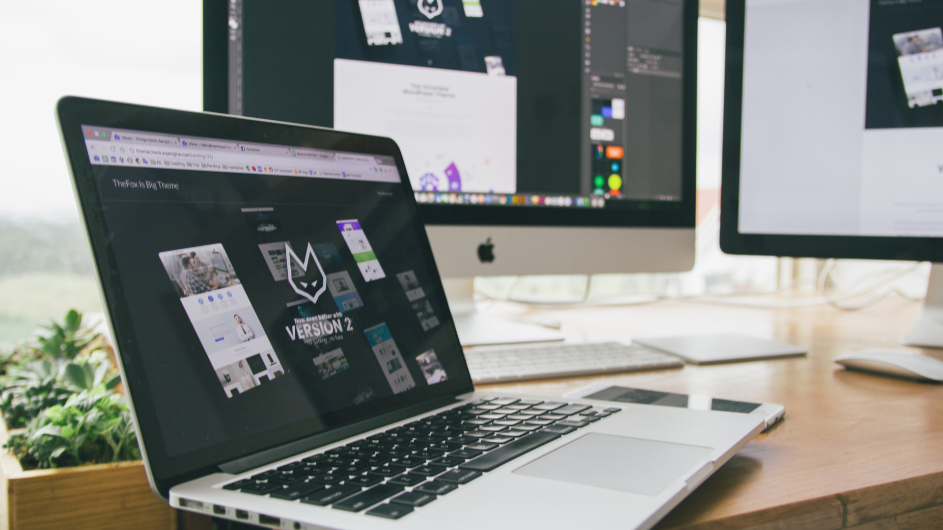 Product design workspace with website layouts on screens