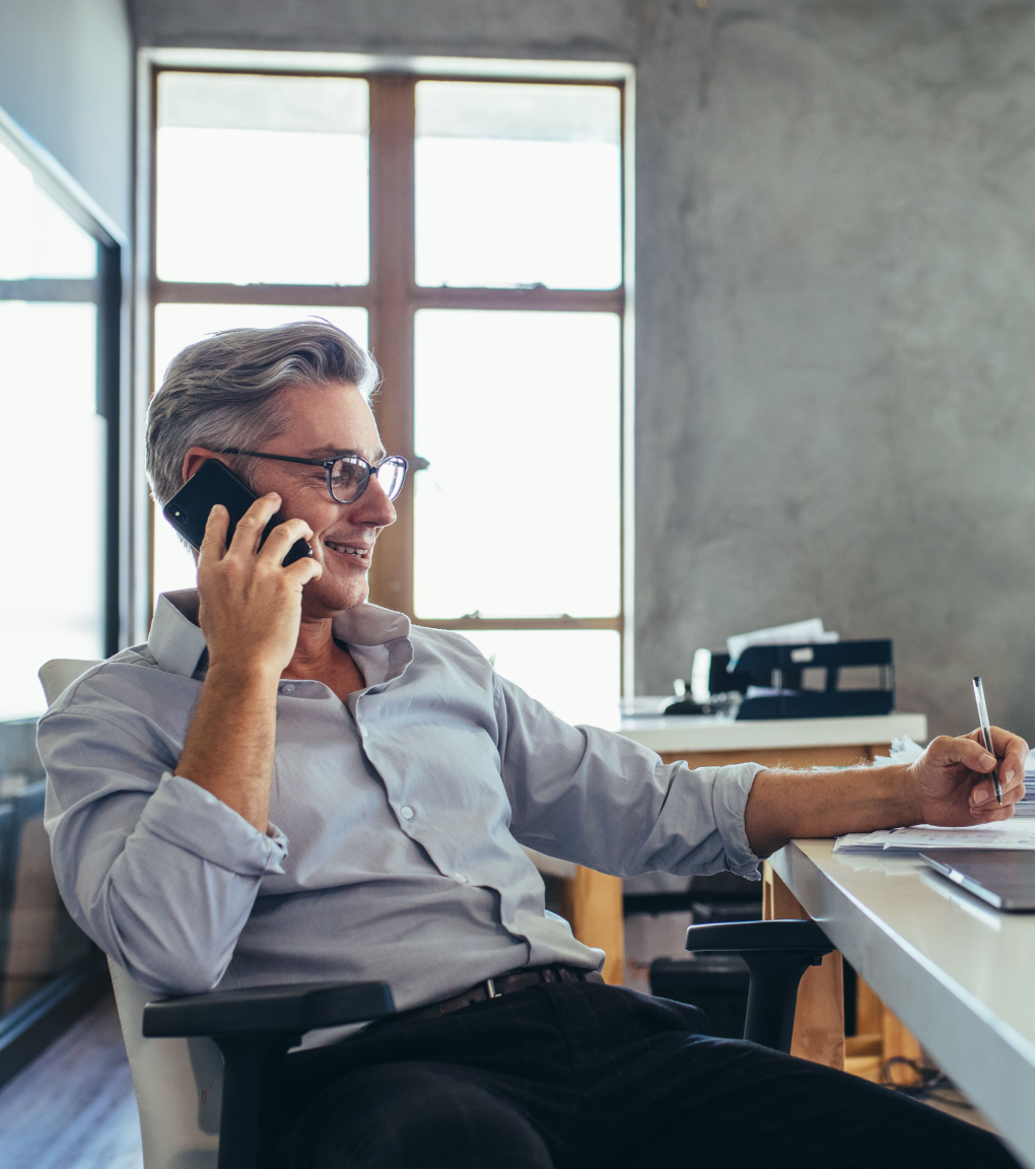 A business man speaking on the phone while sitting