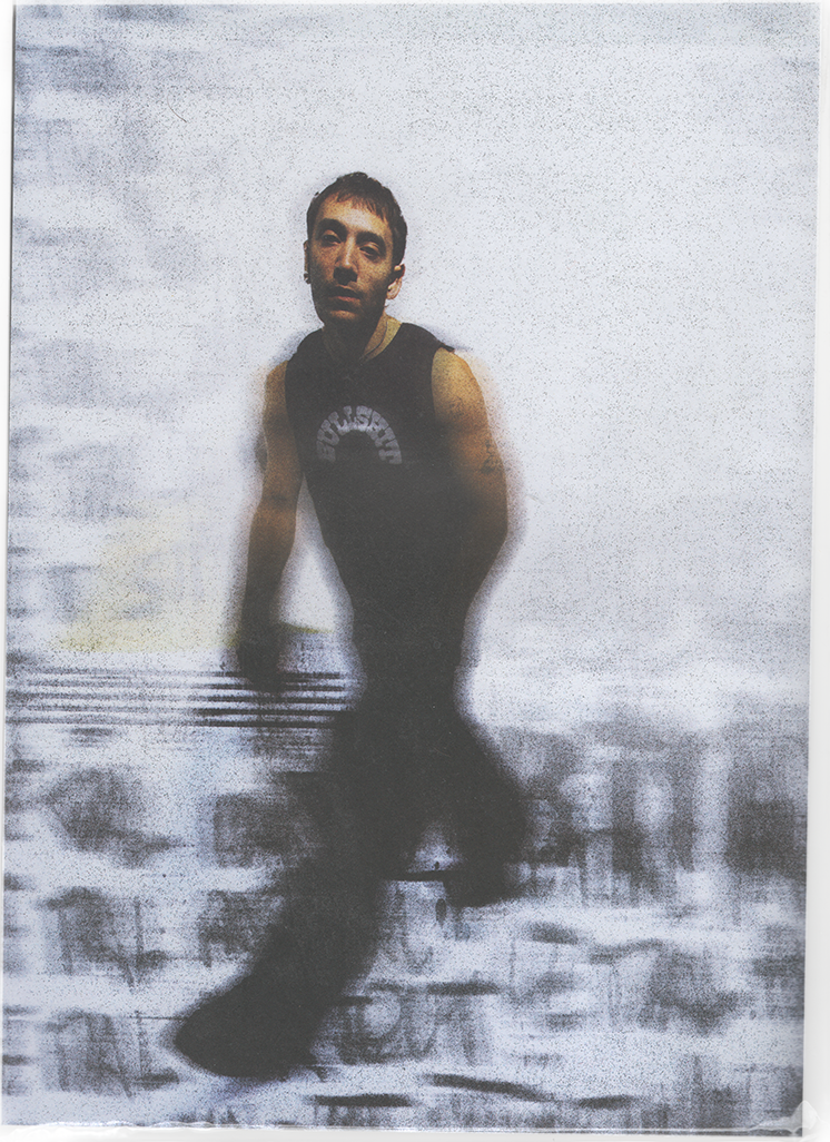 Man in a sleeveless shirt with text standing against a grainy, textured background with blurred horizontal and abstract elements.