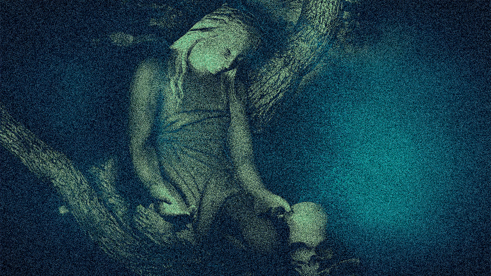 Underwater statue of a woman sitting with head resting on her hand and a skull near her feet.