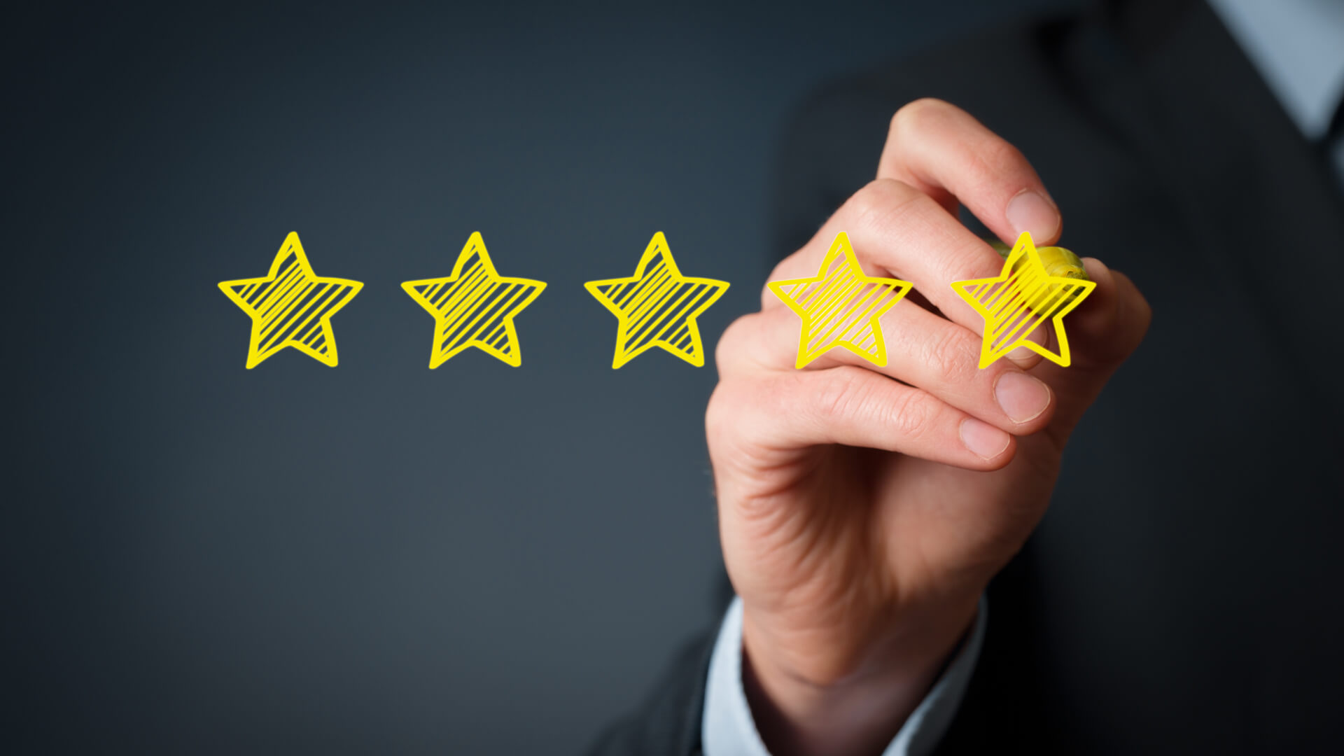 A image of a person drawing review stars on a screen