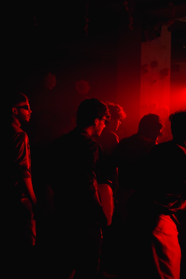 Silhouettes of people in red light
