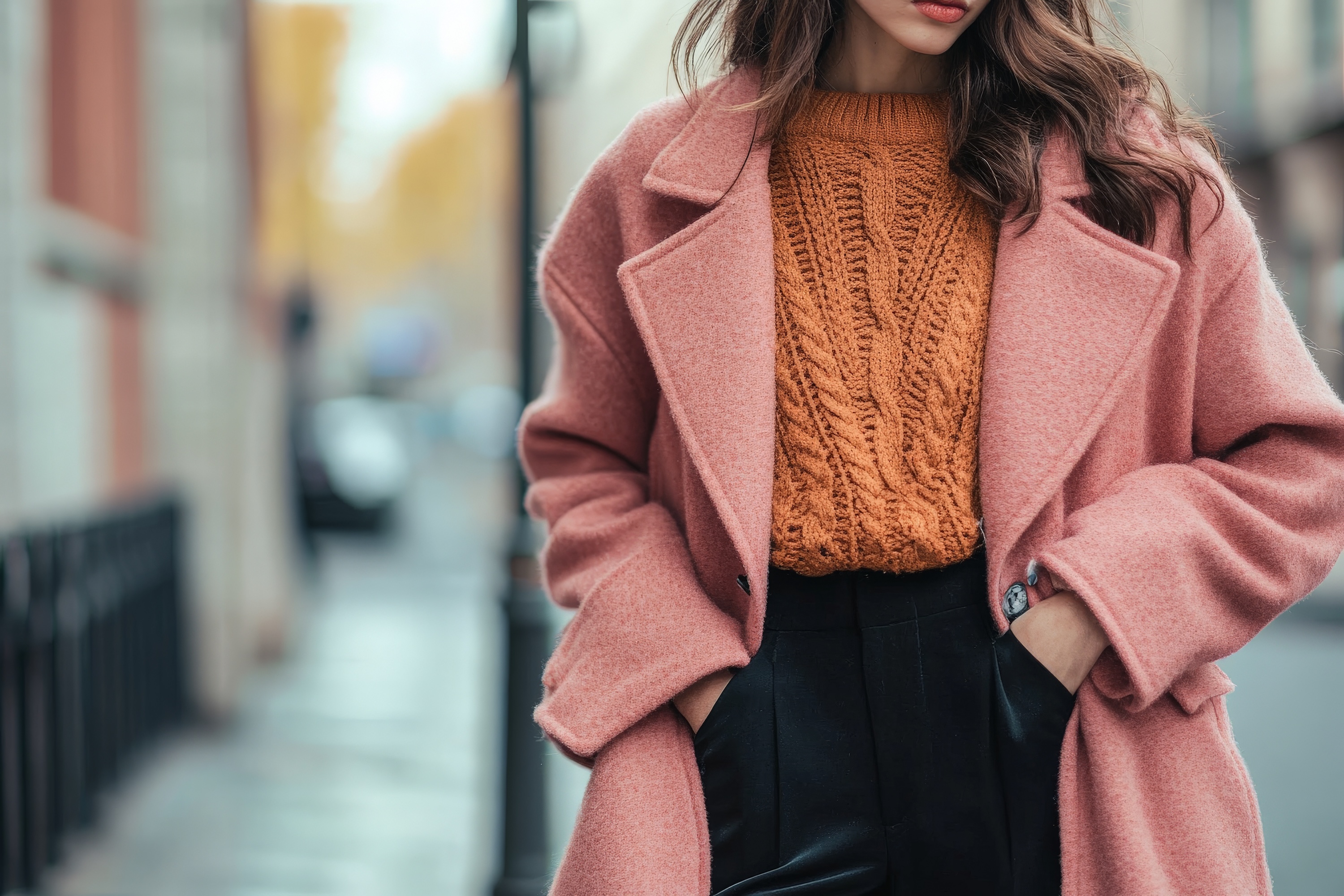 Hand-crafted throw pillows with knitted and woven covers in warm mustard and cream tones, made in a sustainable cut-and-sew home textile factory.