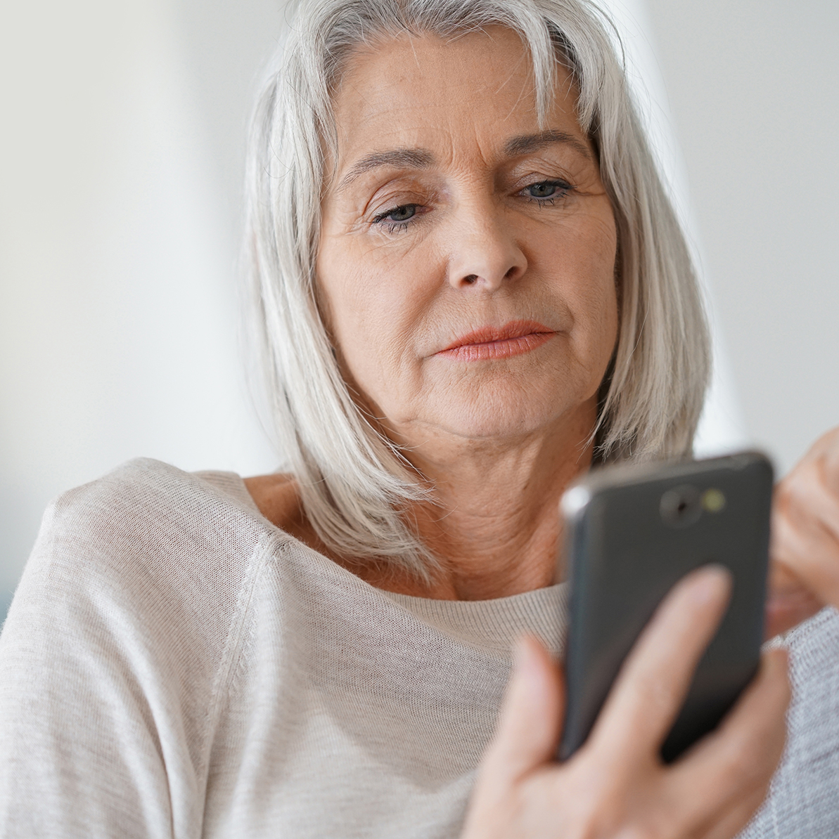 Older woman using the SwissDTx Patient App.