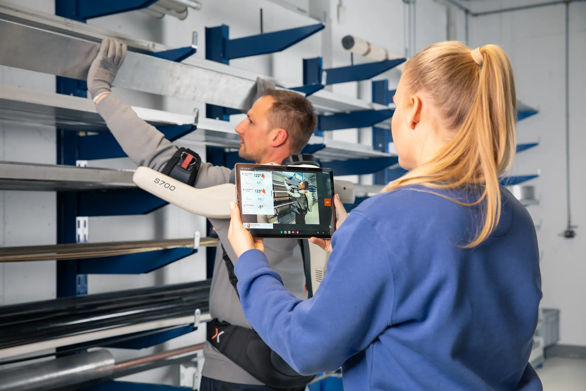 A man and woman are tracking movements with an iPad app.