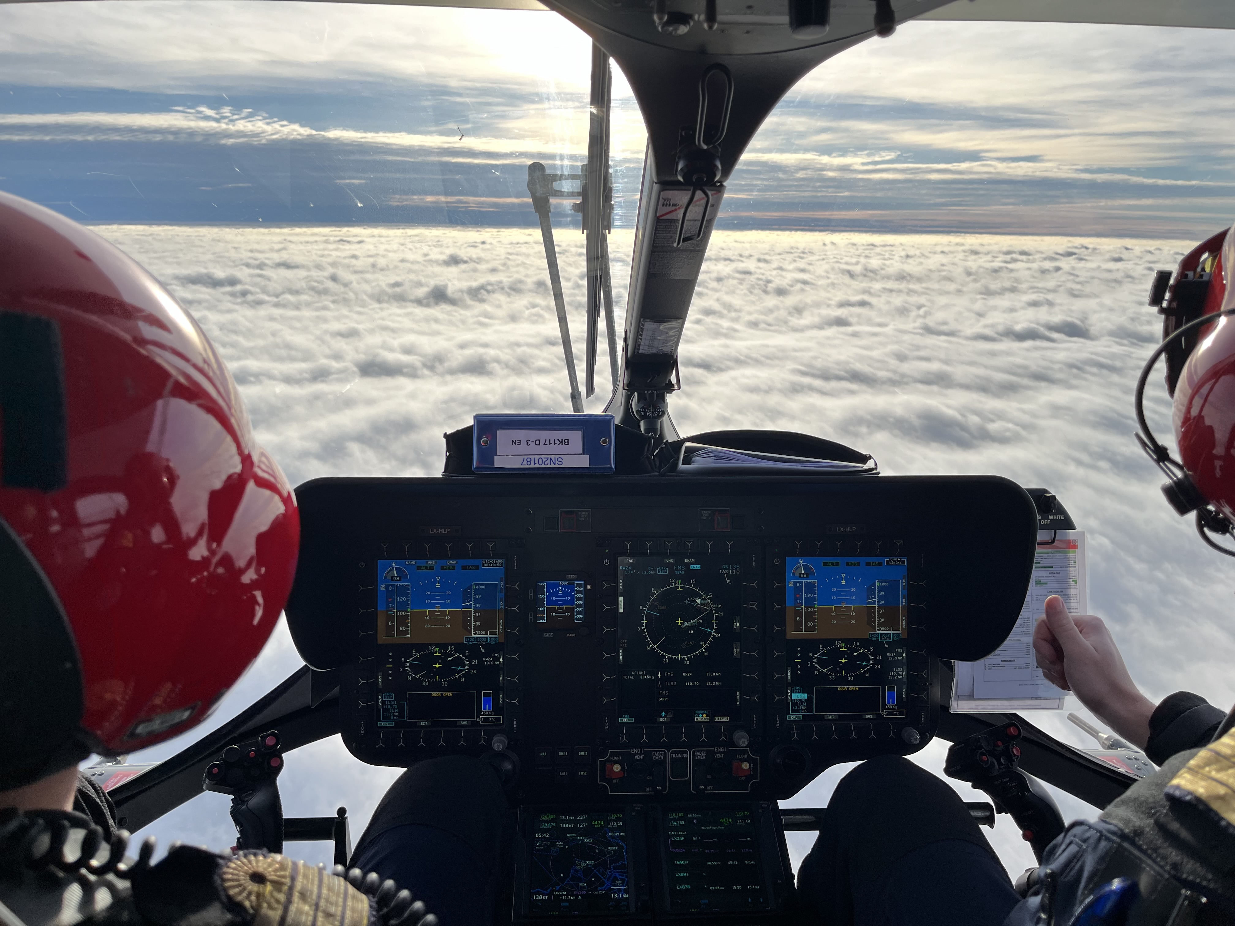 HEMS technical crew member training with crew preparing equipment during a helicopter rescue mission