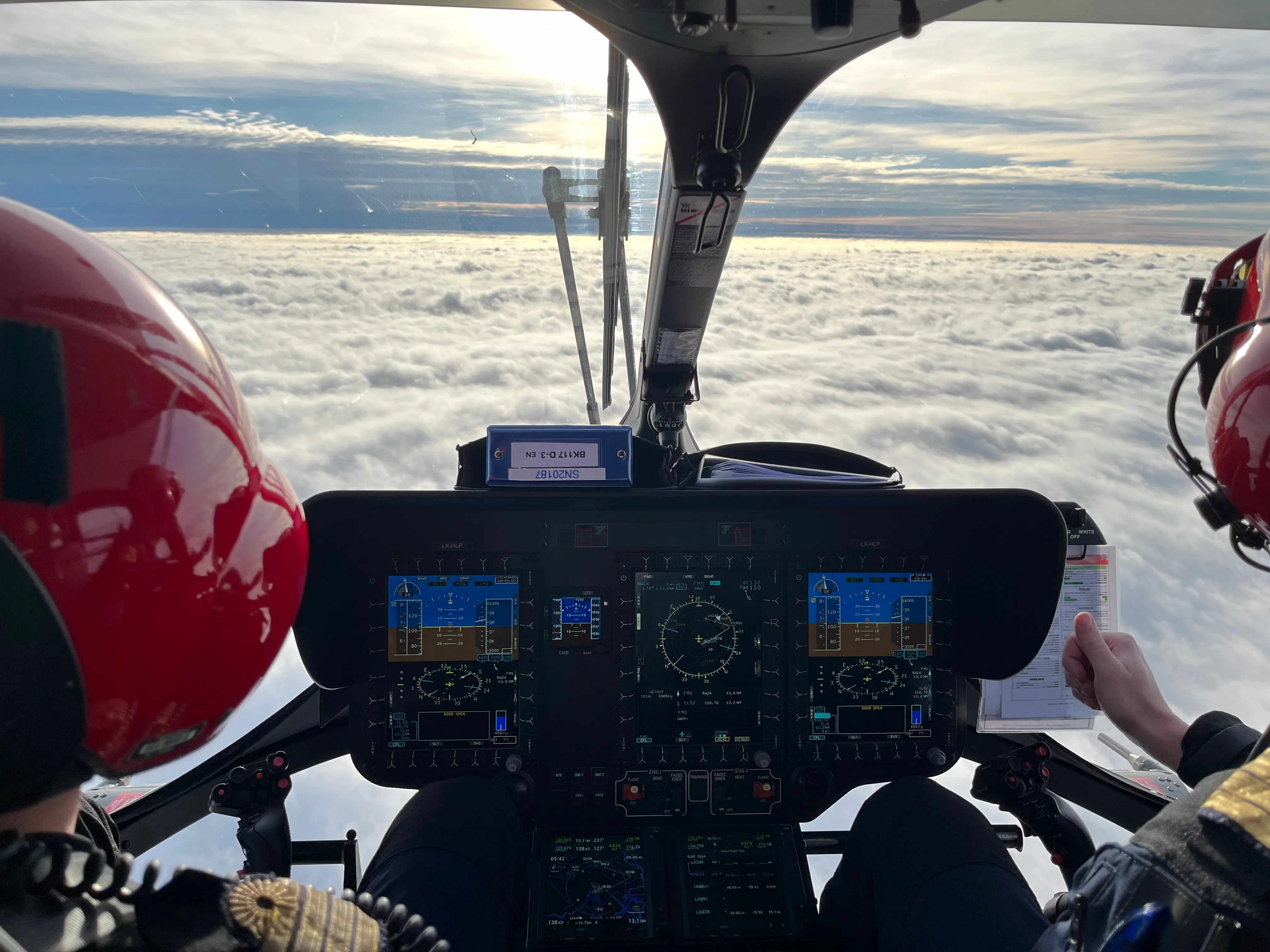 HEMS technical crew member training with crew preparing equipment during a helicopter rescue mission