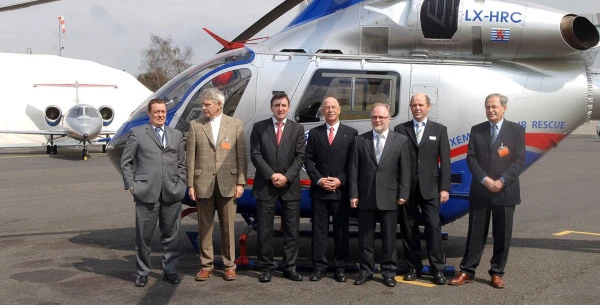 Responsables Luxembourg Air Rescue devant un hélicoptère (LX-HRC) lors d’une présentation officielle de la flotte de secours aérien.