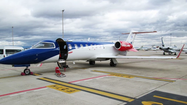 Jet ambulance Luxembourg Air Rescue sur piste avec porte ouverte, prêt pour une mission d’évacuation médicale internationale.