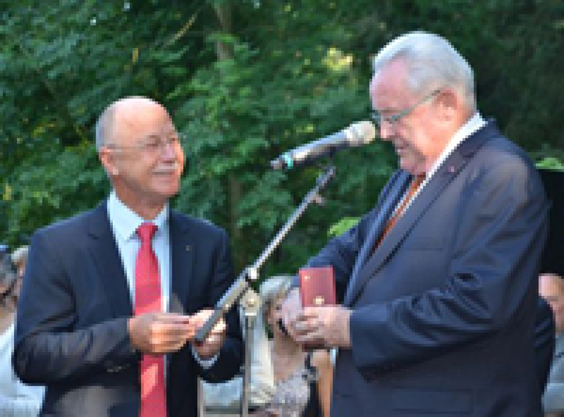 Belgian ambassador presenting René Closter with the Order of the Crown during an official reception in Luxembourg.