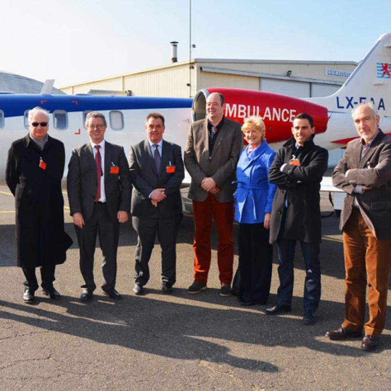 Members of the parliamentary committee visiting Luxembourg Air Rescue with staff during a guided tour of the Findel air rescue base.
