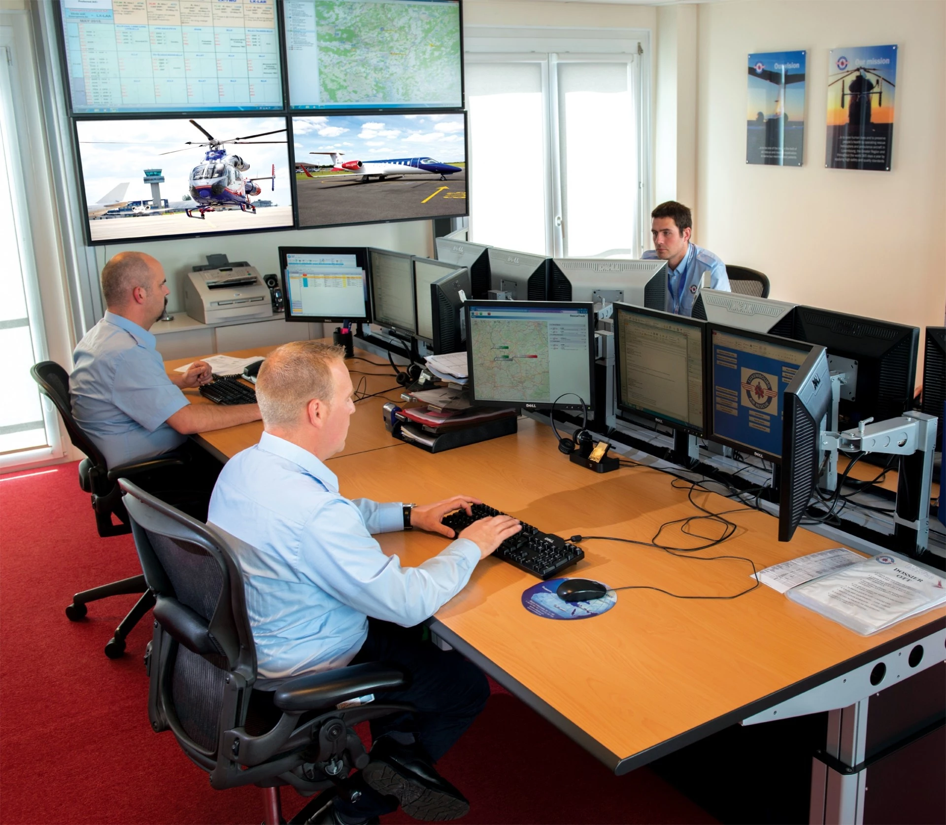 Luxembourg Air Rescue staff working at night in the control centre coordinating emergency helicopter and air ambulance missions during New Year’s Eve.