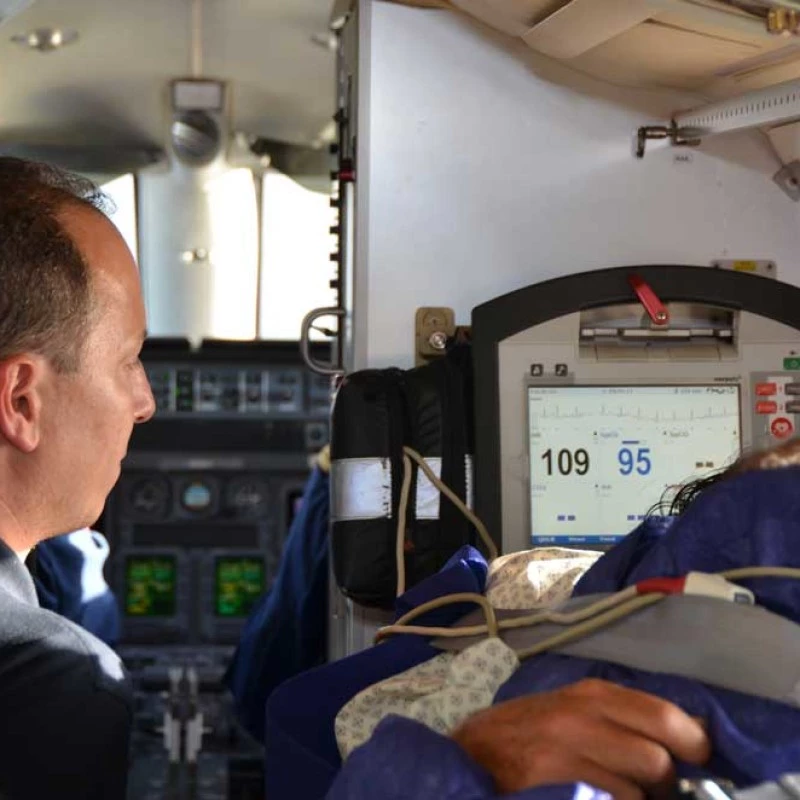 Medical team monitoring a patient inside an air ambulance aircraft