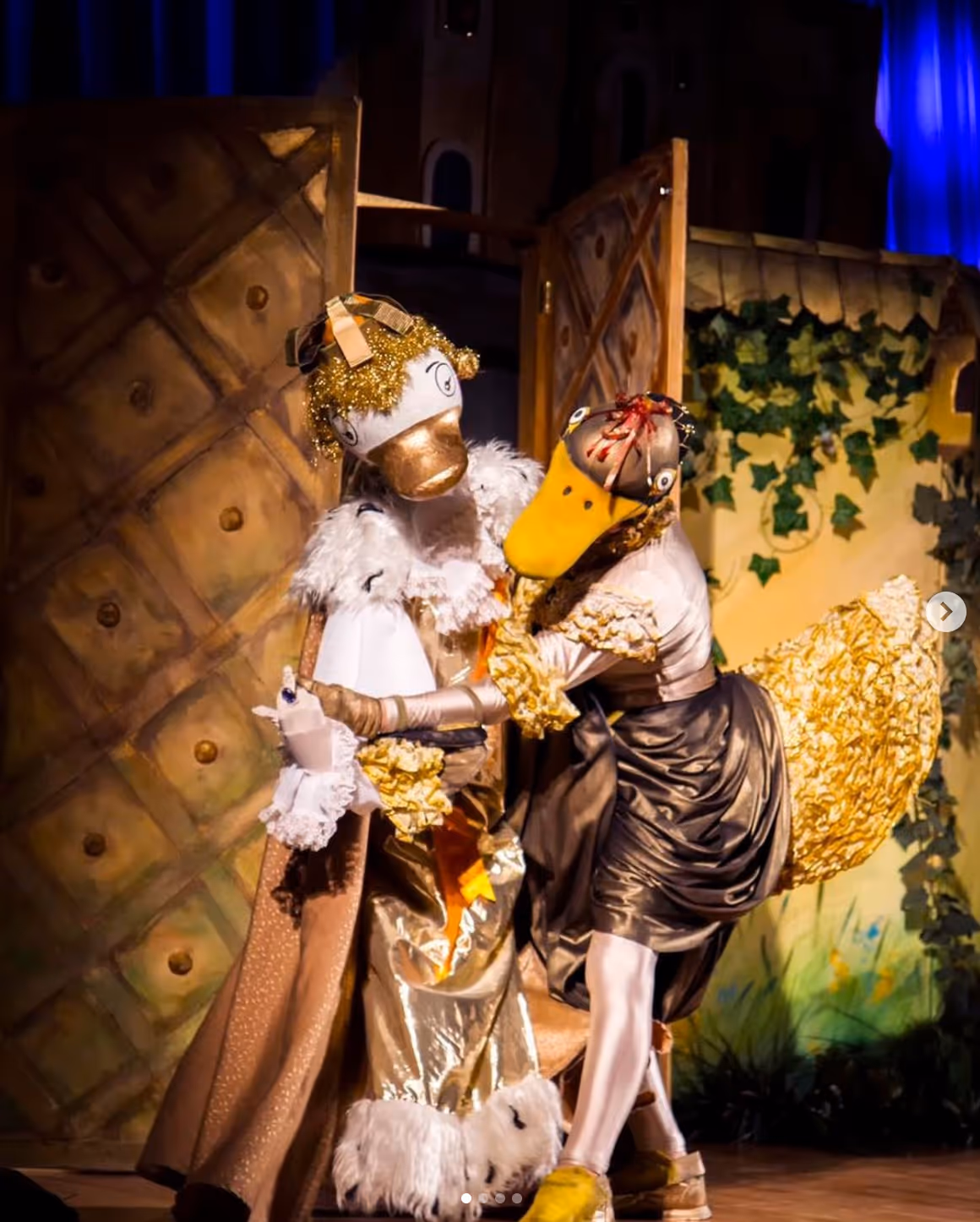 Scena ze spektaklu "Złota kaczka i duch starego zamku" - dwie kaczki tańczące na tle scenografii.