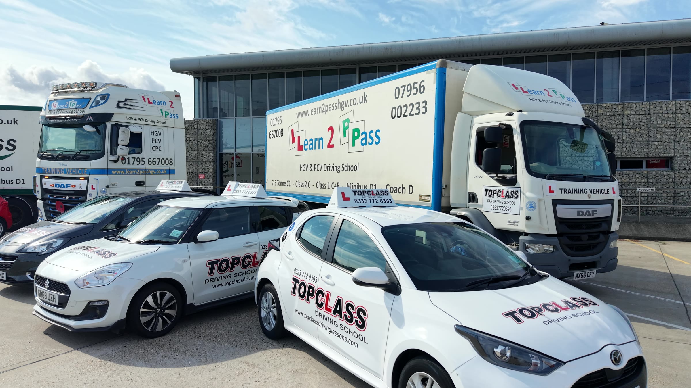 White Topclass cars in front of a Learn2Pass lorry