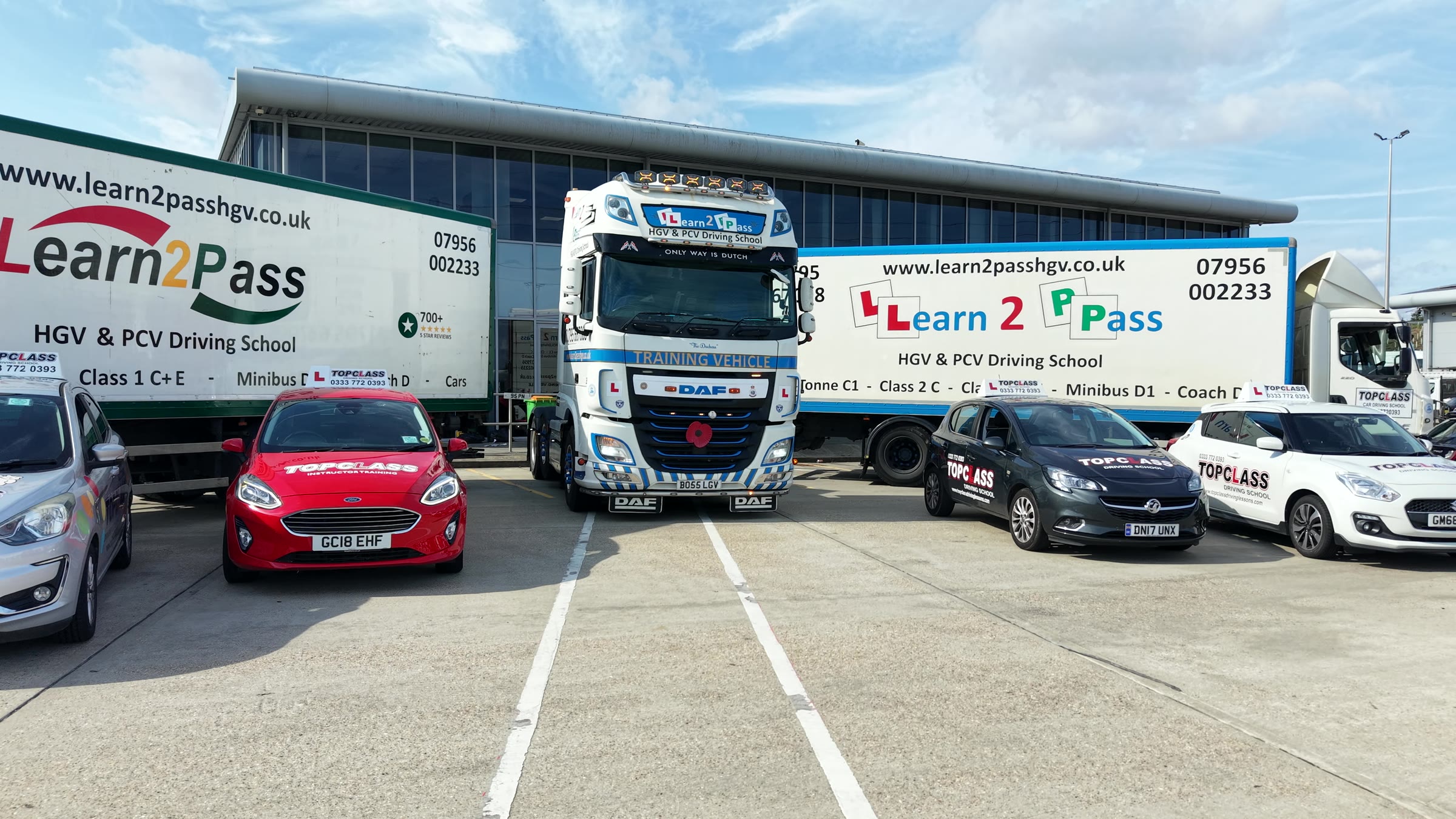 Topclass cars parked in front of Learn2Pass lorries