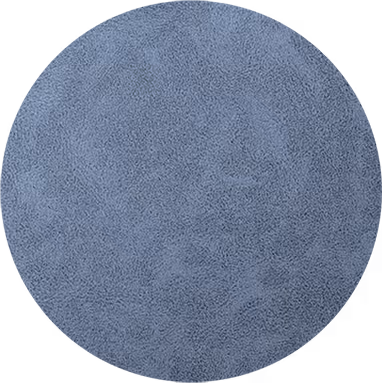 Surface bleu-gris texturée en forme de cercle avec aspect granuleux.