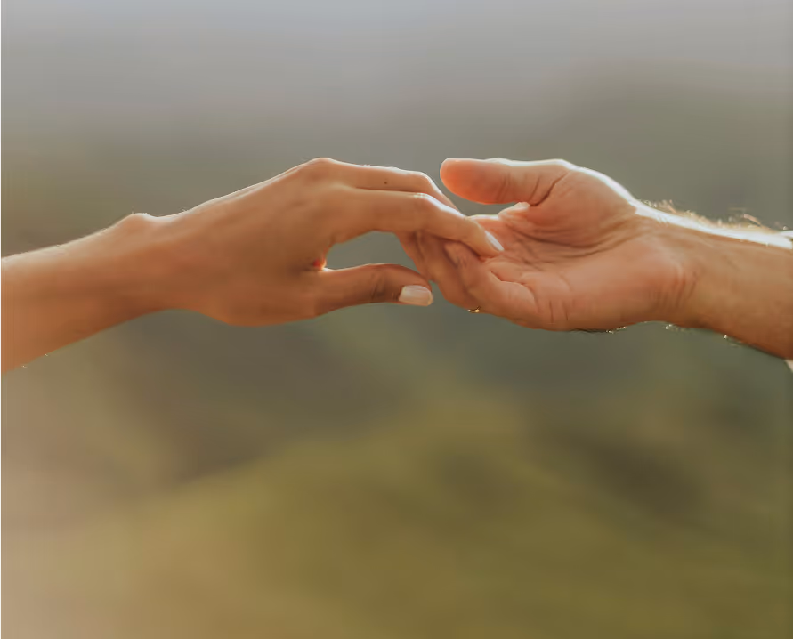 Two hands reaching toward each other