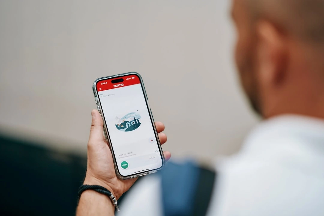Customer booking a car service on a smartphone in a comfortable home setting - web scheduler for auto repair shops Customer booking a car service on a smartphone in a comfortable home setting - web scheduler for auto repair shops
