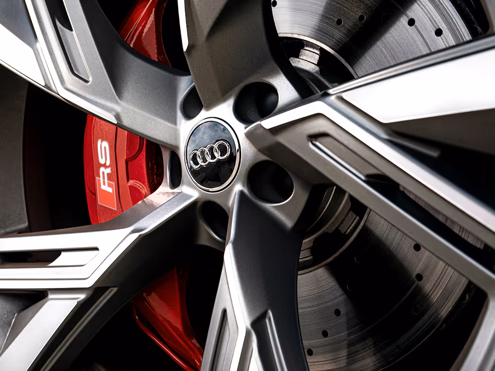 Close-up detail of Audi RS wheel and red brake caliper, precision automotive photography by Roe Photo.