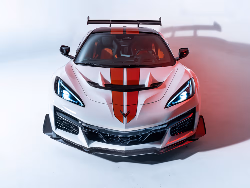 Front view of white Corvette Z06 with red racing stripe in studio lighting, high-performance automotive photography by Roe Photo.