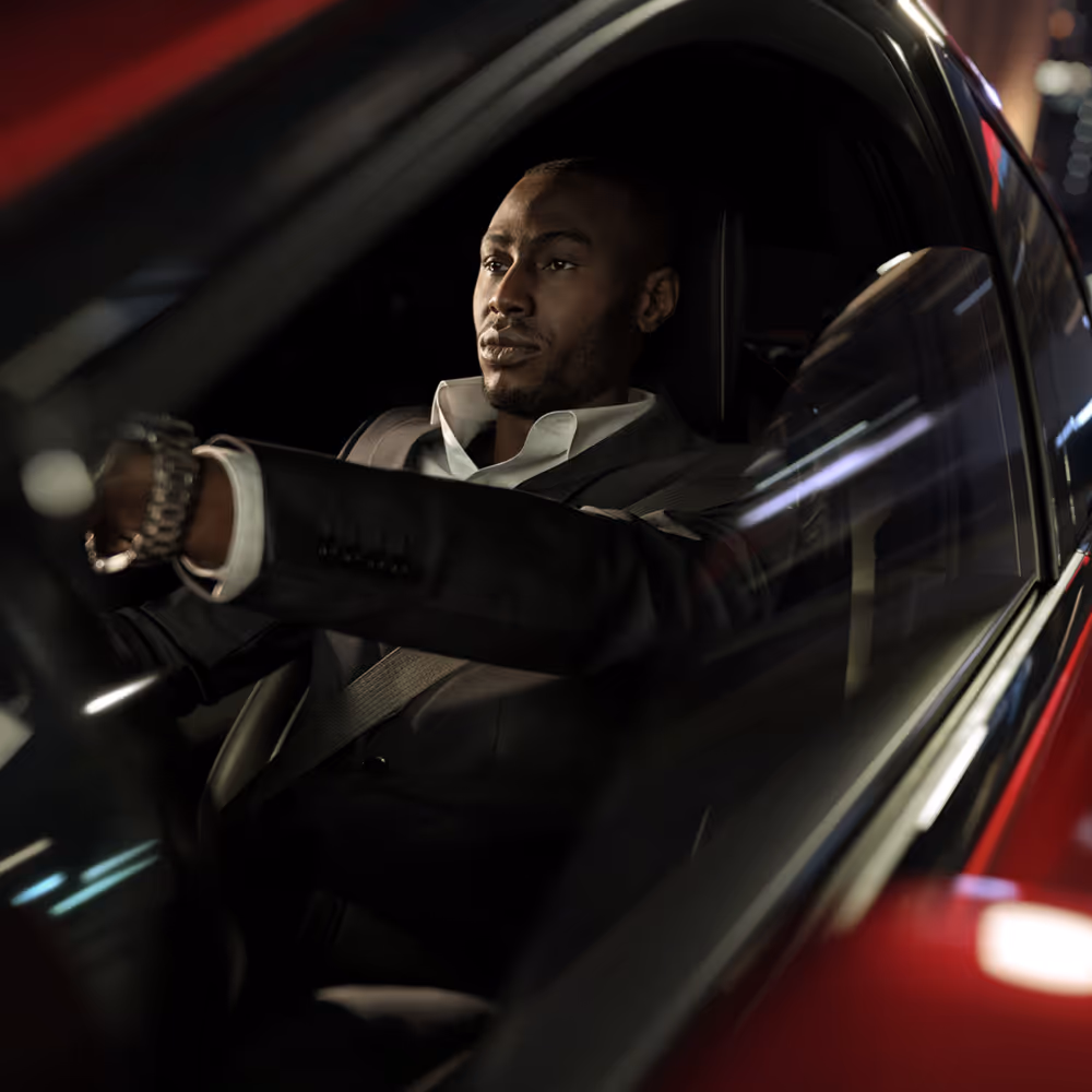 Portrait of man driving a red luxury car at night, cinematic automotive lifestyle photography by Roe Photo.