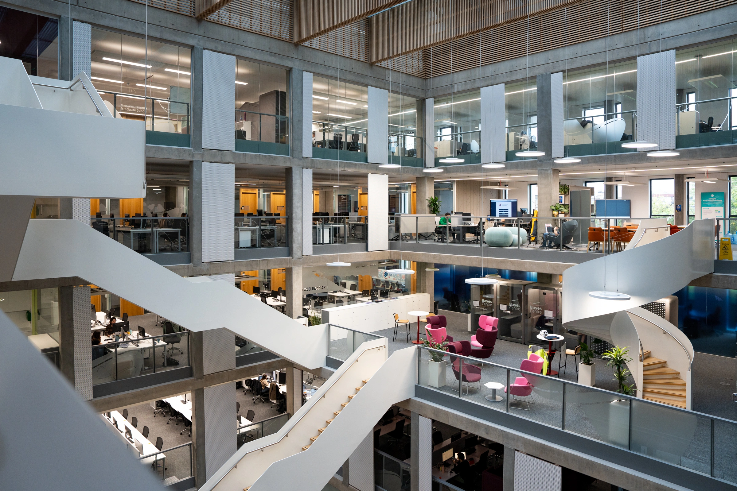 Interior view of Bayes Centre showing multi-level open workspace with modern offices, collaborative areas and meeting spaces