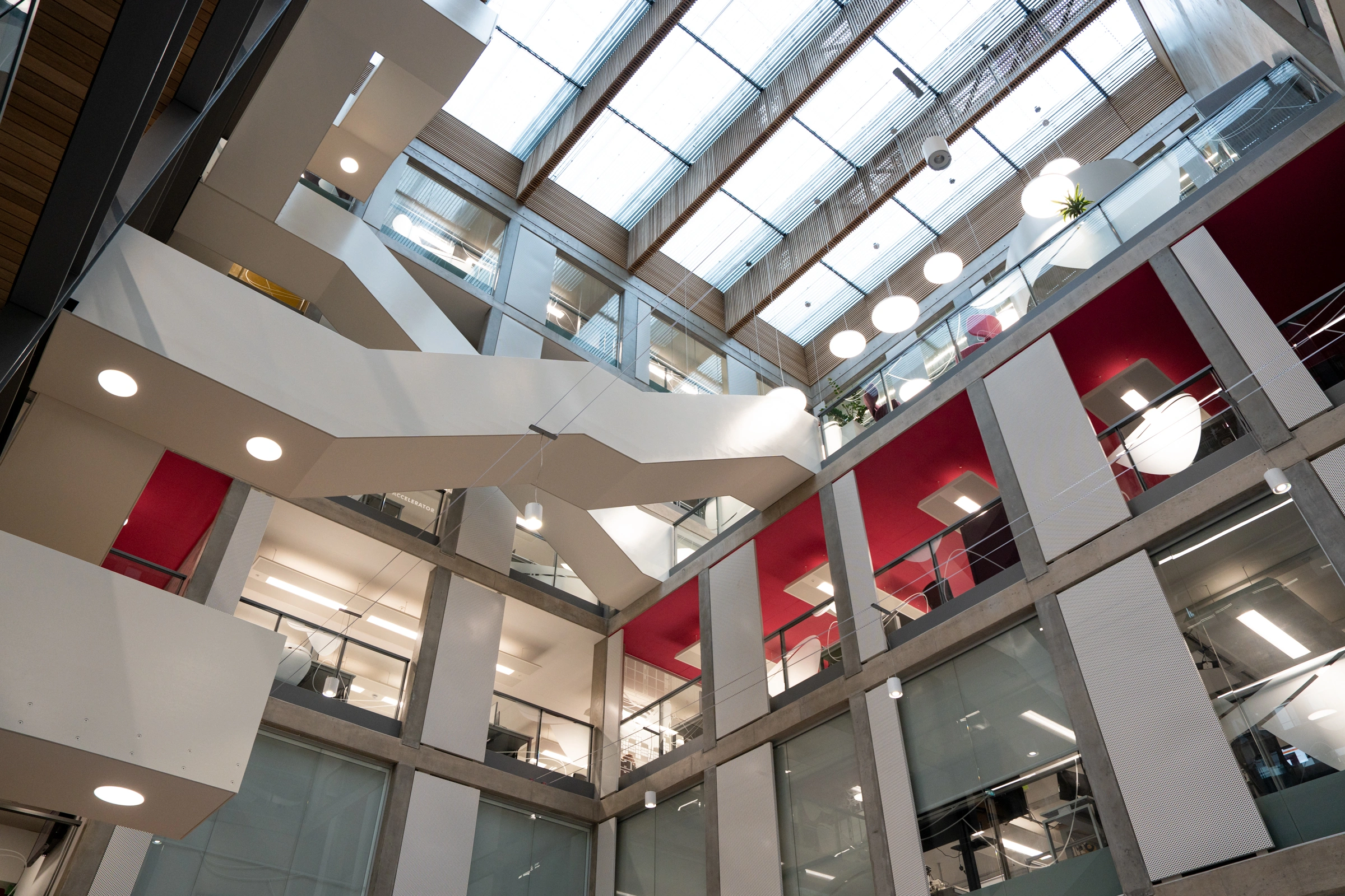 Interior view of Bayes Centre showing multi-level open workspace with modern offices, collaborative areas and meeting spaces