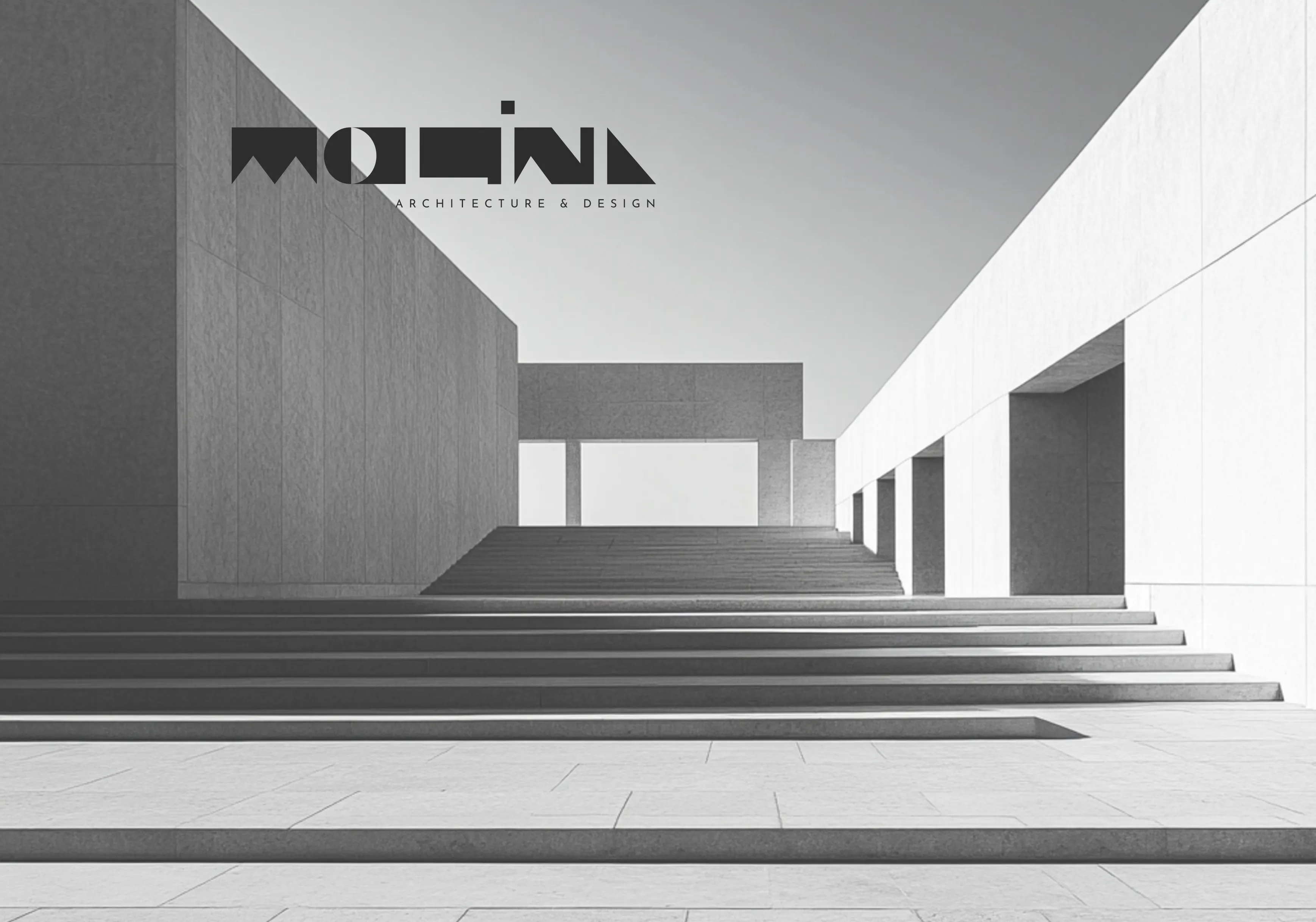 Monochrome image of modern minimalist architecture featuring wide stone steps flanked by large flat walls and a clear sky background.