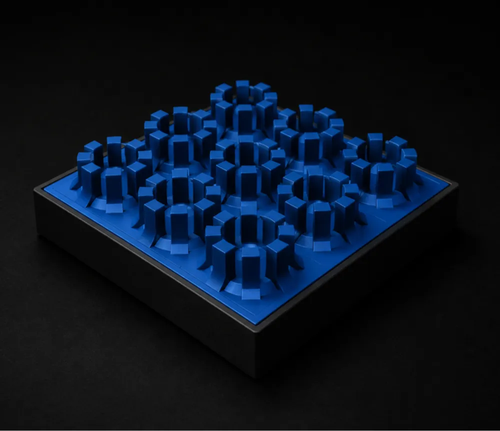 Square black base with raised blue plastic gear-like structures in a 4 by 4 grid.