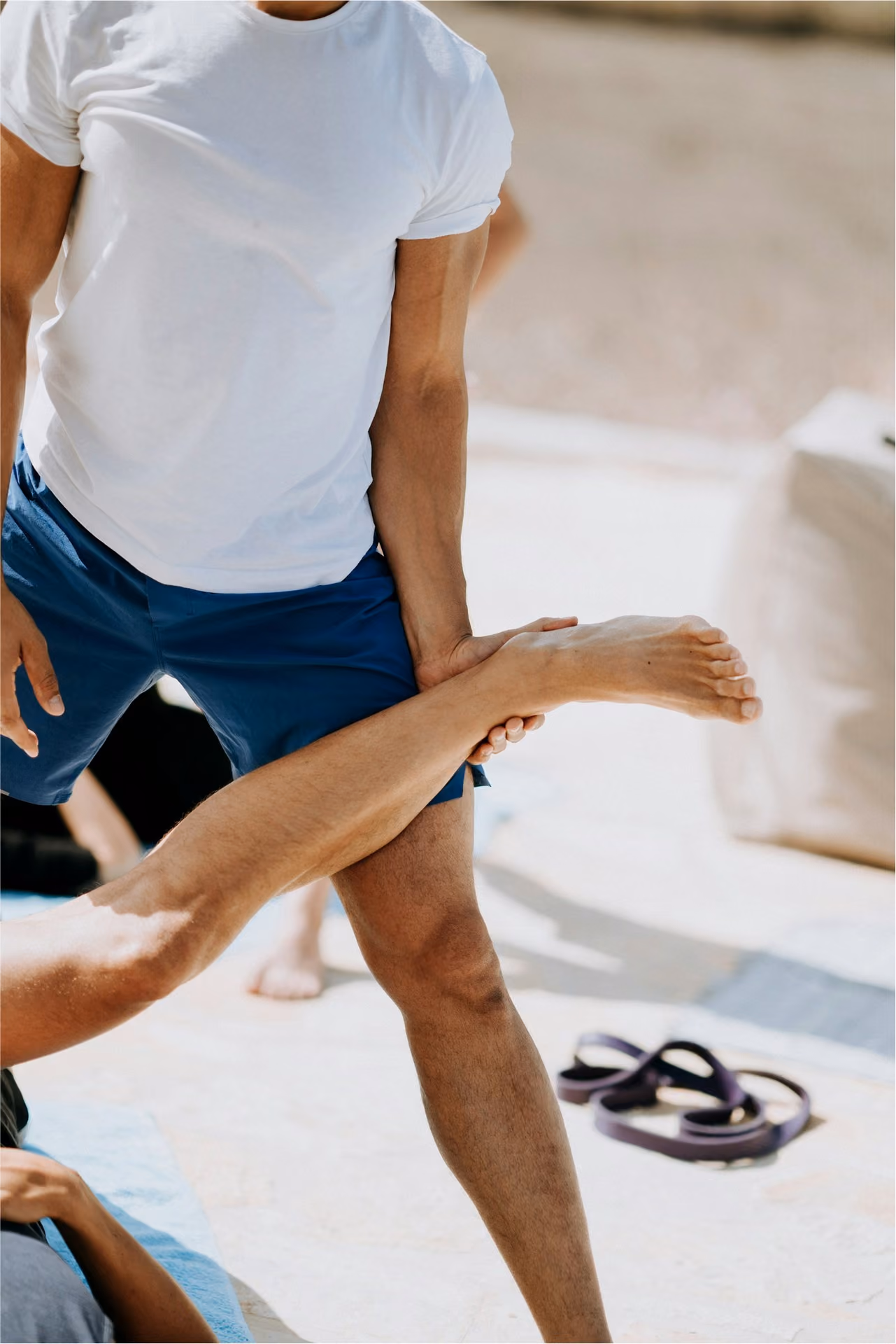 A therapist stretching a client's leg during a treatment session