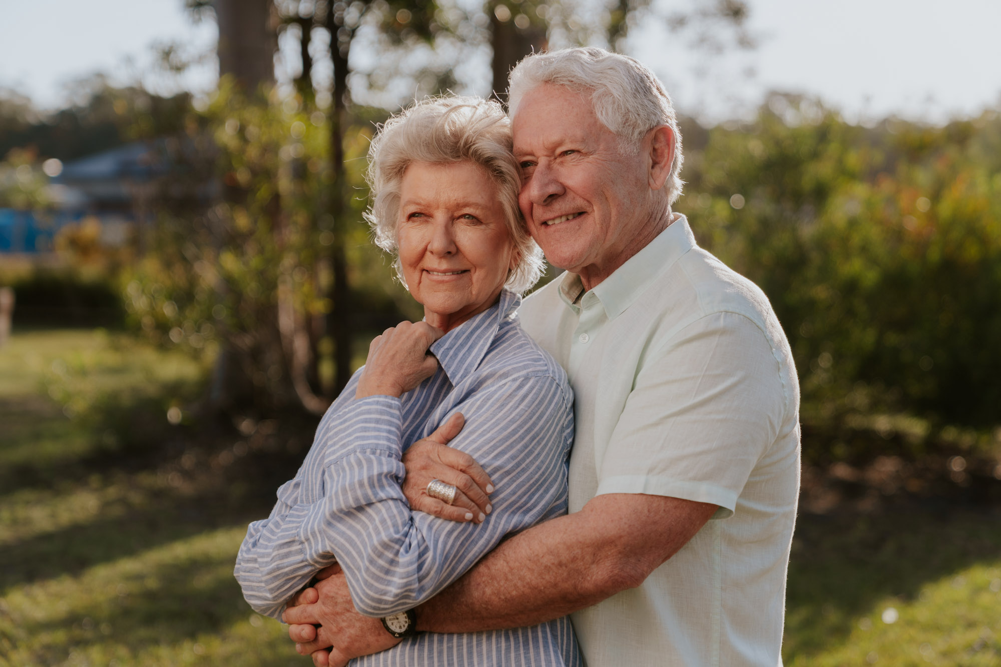 older women and man holding each other