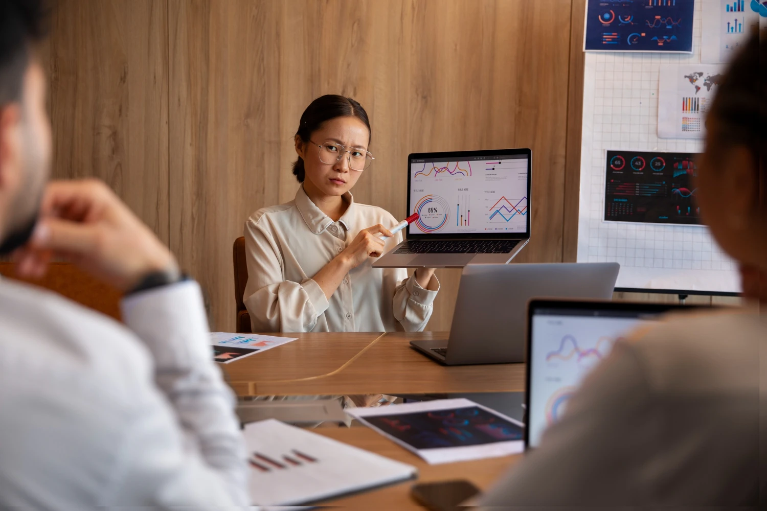 Two team members in a meeting room with a whiteboard discussing distributed training data pipelines and system architecture in a collaborative work setting