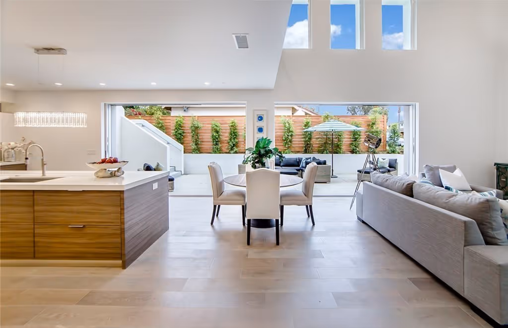 Looking out through kitchen and living room through 2 large open pocket sliding doors to the patio.