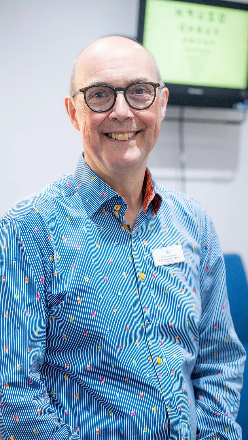 Smiling older professional in colorful dotted shirt and glasses