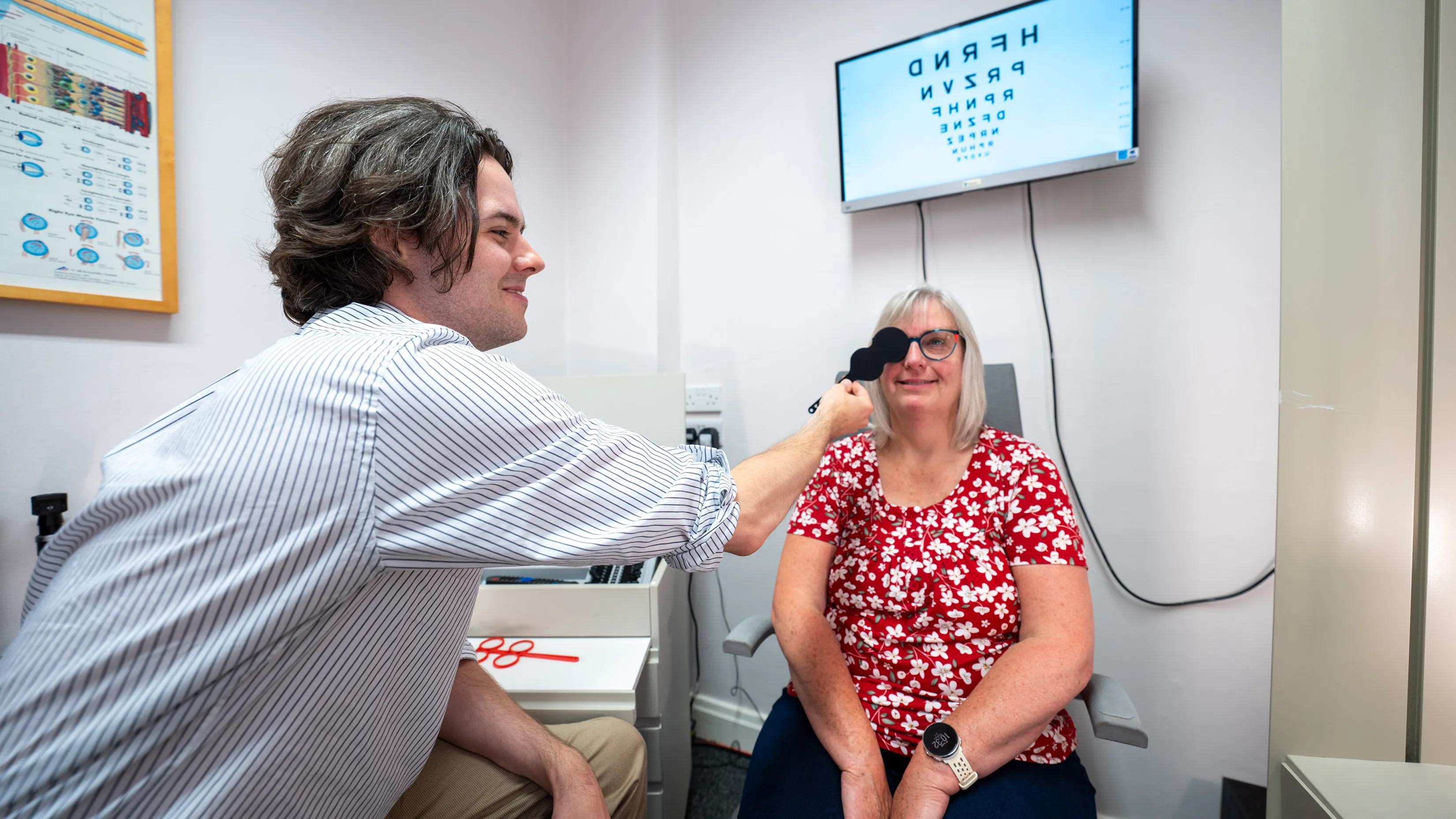 Eye exam with patient getting vision tested in medical office