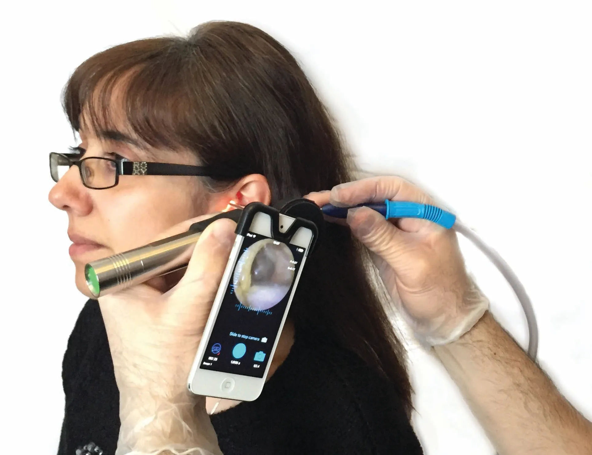Smartphone ear examination with digital otoscope showing inner ear view