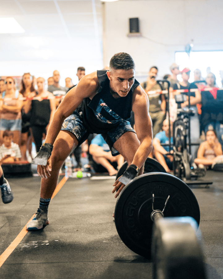 Athlete jumping over bar at member only event