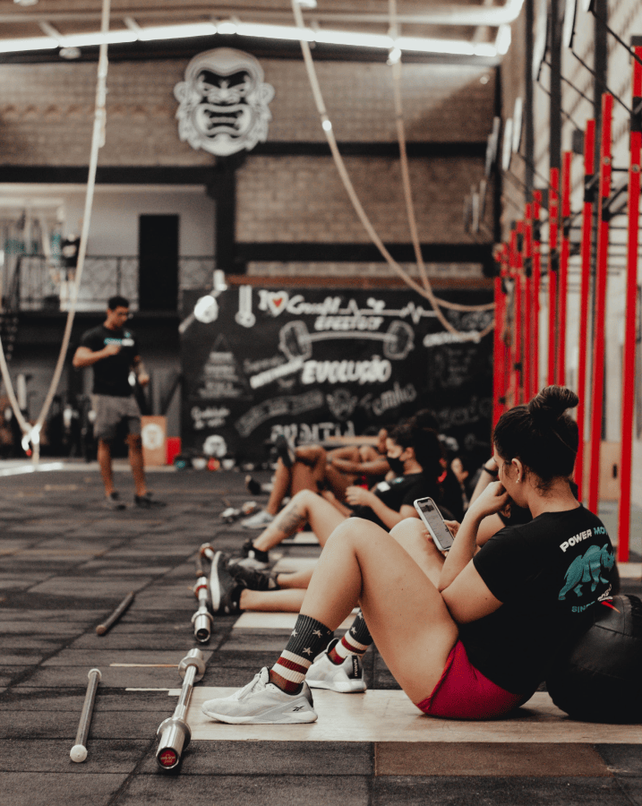 CrossFit Gym class with athletes sitting on floor