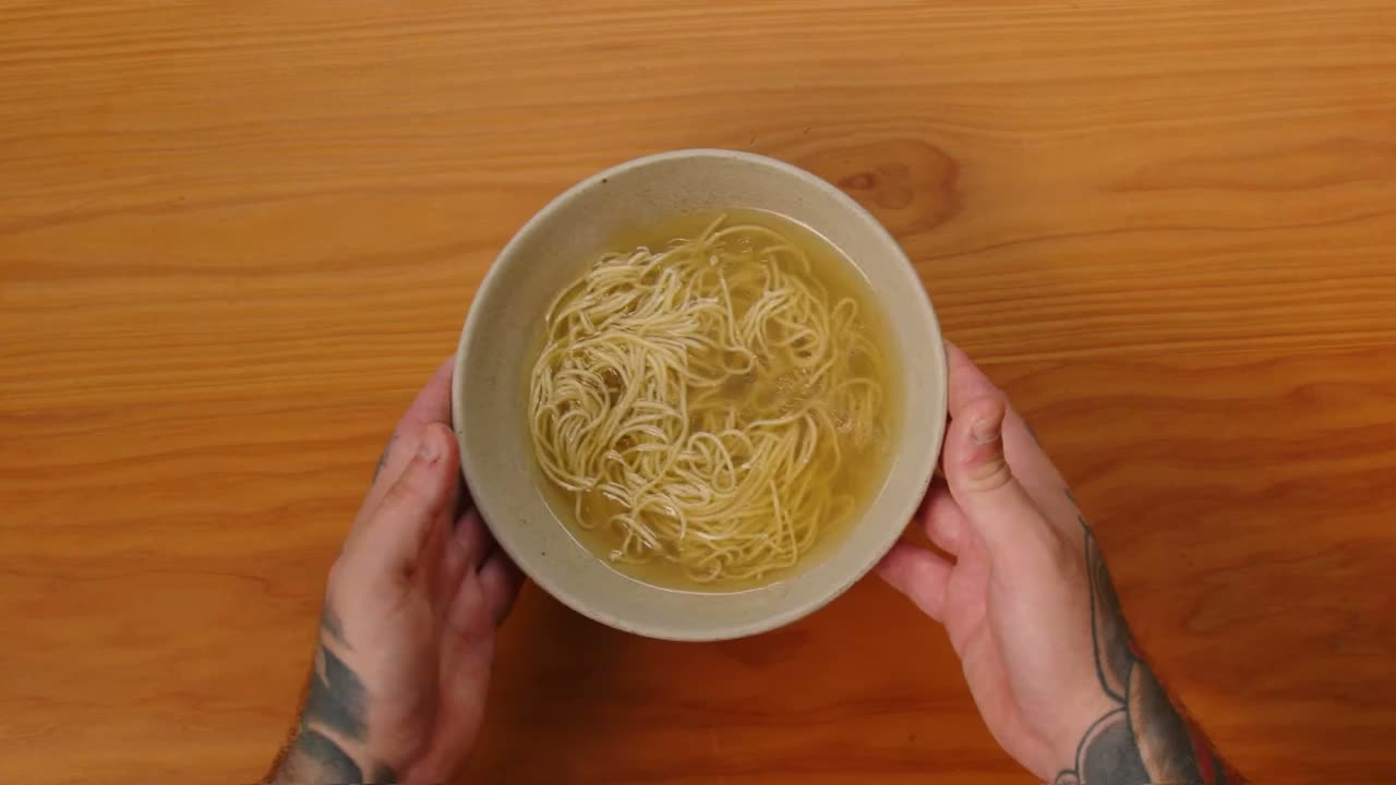 A bowl of Slurp noodles and broth seen from above.