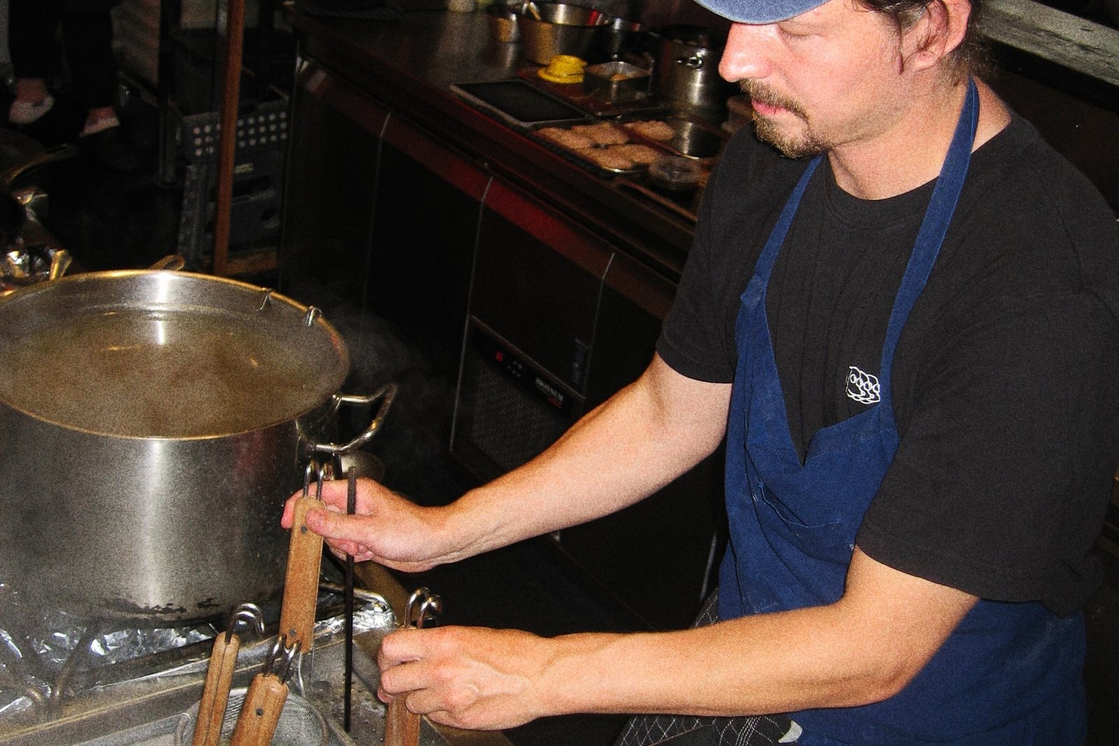 The open kitchen at Slurp, visible from the counter where a family can watch the cooks work while they wait
