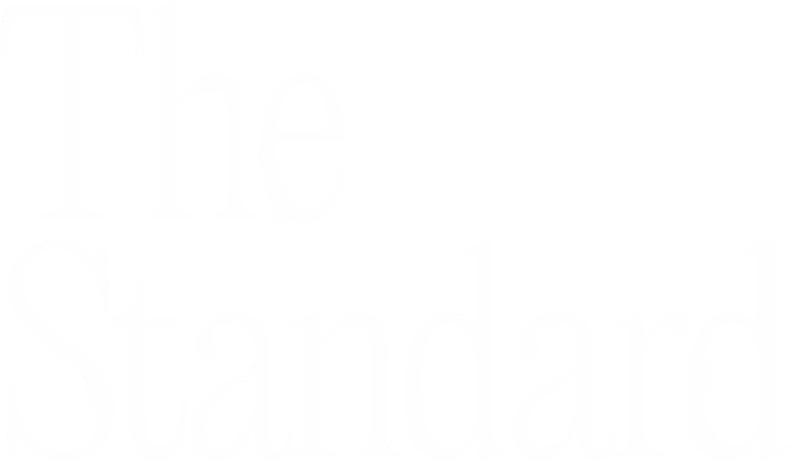 White text reading 'The Standard' on a black background in a serif font.