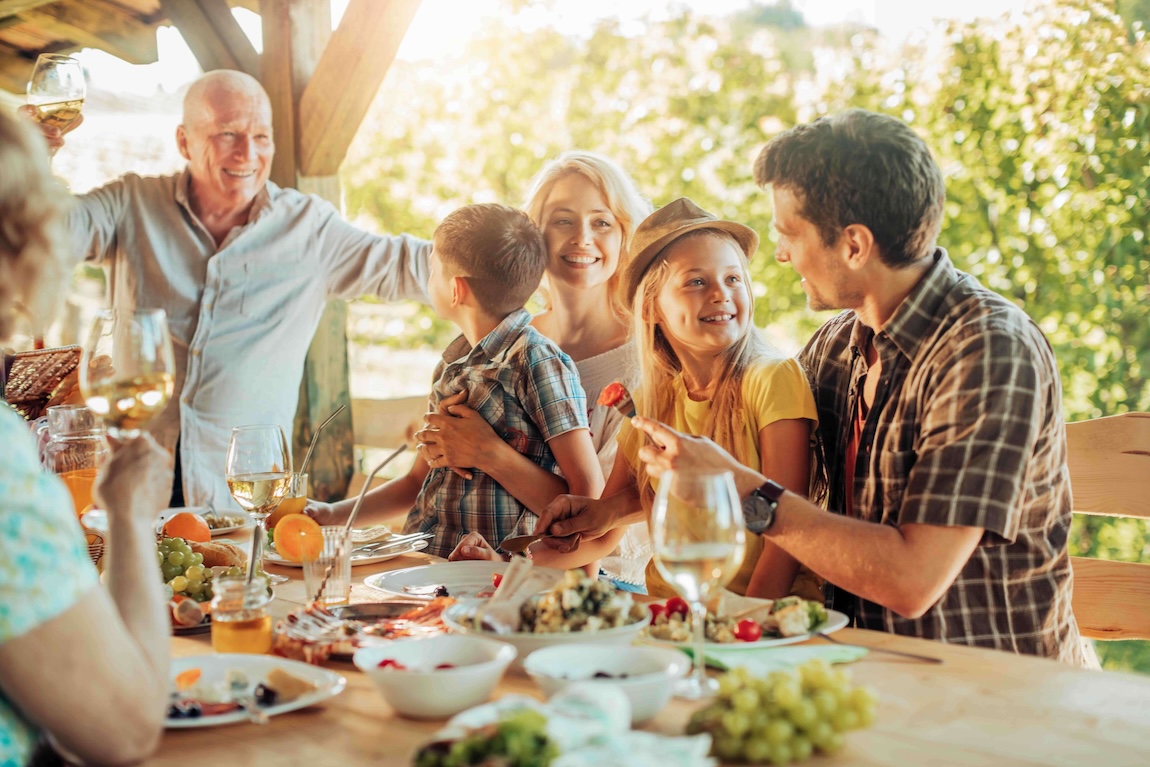 Multigenerational family celebrating together, symbolizing peace of mind after estate planning resolution.